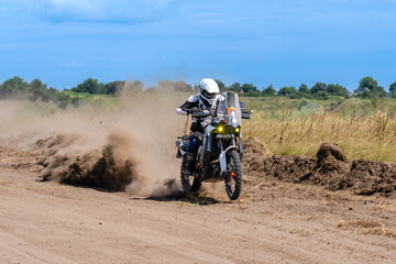 Motocross rider riding on extreme dust track