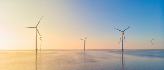 Windmill park in the ocean, drone aerial view of windmill turbines generating green energy electric