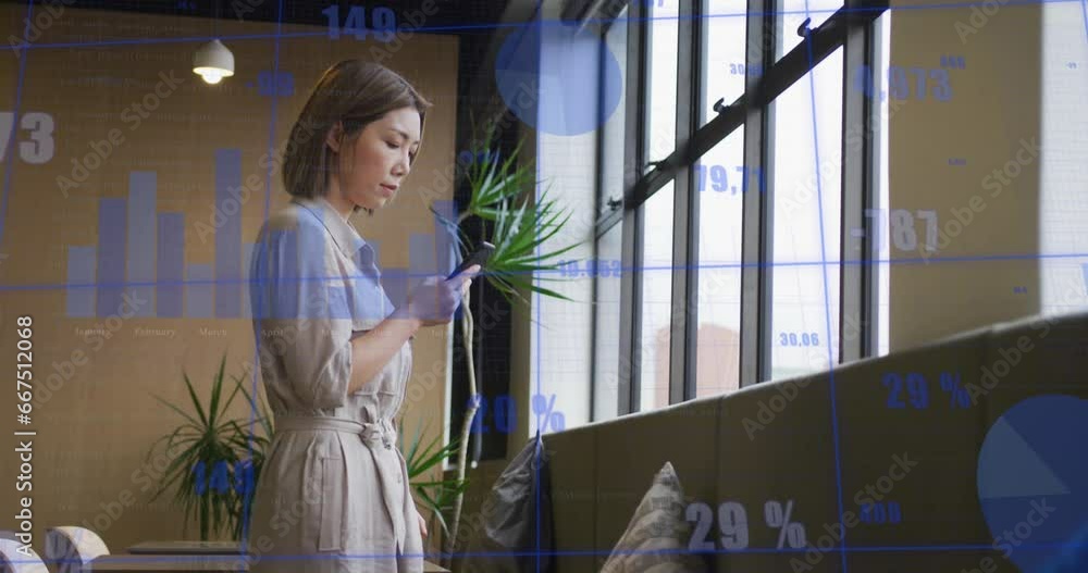Poster animation of graphs and changing numbers over asian woman standing near window and using cellphone