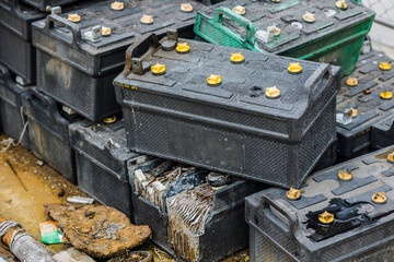 Battery waste. Pile of old used EV car batteries toxic waste chemicals lead leak impact nature no...