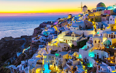 White churches an blue domes by the ocean of Oia Santorini Greece, a traditional Greek village in...