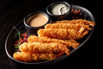 crispy shrimp tempura with garlic sauce on plate