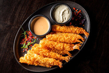 crispy shrimp tempura with garlic sauce on plate