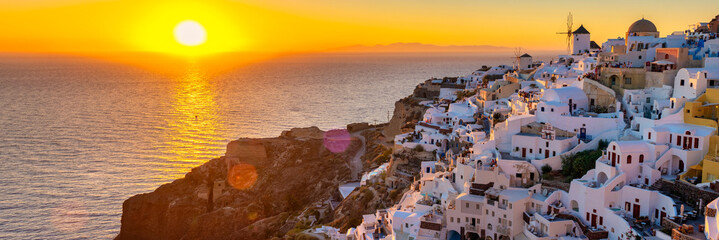 White churches and blue domes by the ocean of Oia Santorini Greece, a traditional Greek village in...