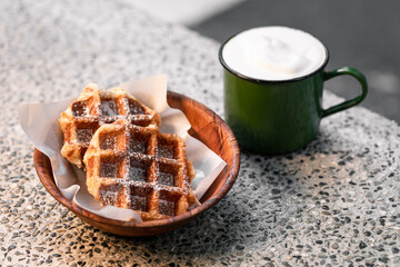 A combination meal of waffles and milk tea