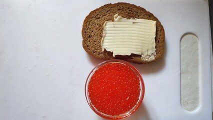 sandwich with black bread, butter and red caviar, food snack, breakfast