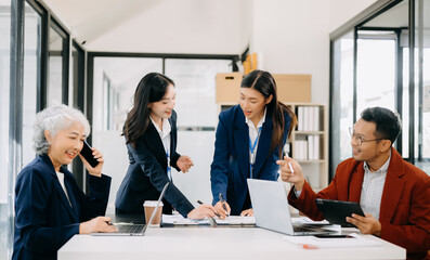 Business team discuss at meeting room. working together with laptop ,tablet and smart phone on desk Financial accountant , planner , meeting , introduction concept.