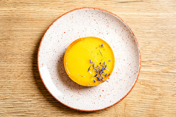 lemon tart with flower petals, top view