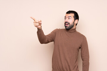 Man over isolated background pointing away