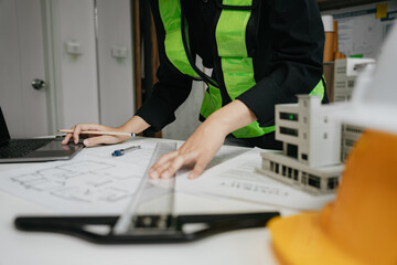 architect or engineer working on table use drawing tool on the paper plan for business architectural project.