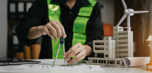 architect or engineer working on table use drawing tool on the paper plan for business architectural project.