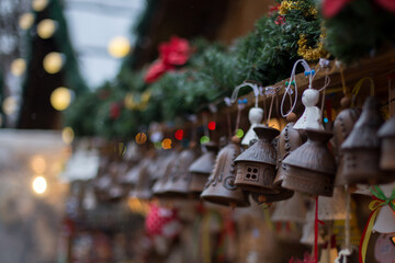 Ceramic decorative handmade bells and other toys hang from the roof of the souvenir shop at the...