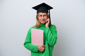 Young university graduate woman isolated on white background frustrated and covering ears