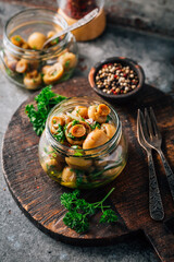 Homemade pickled mushrooms in a jar with spices