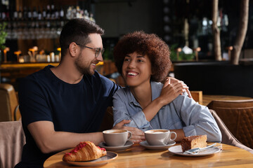 International dating. Lovely couple spending time together in cafe