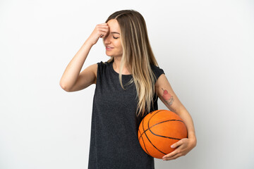 Young woman playing basketball over isolated white wall laughing