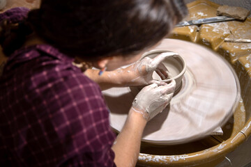 Young female potter working in her workshop in Antibes in the south of France