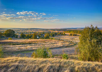Obraz premium Perfect landscape view before the sunset. Warm sunny light and perfect clouds made a beautiful mood