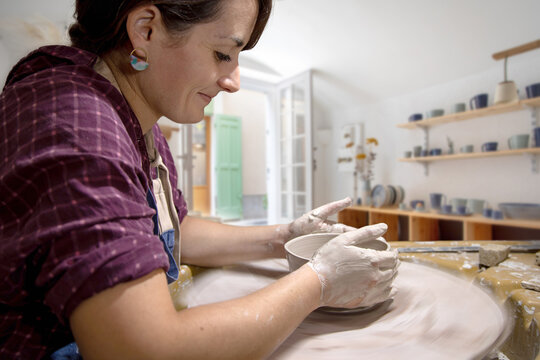 Young female potter working in her workshop in Antibes in the south of France