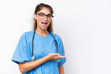 Young nurse doctor woman isolated on white background presenting an idea while looking smiling towards