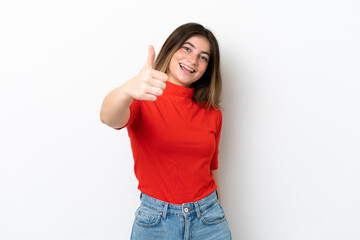 Obraz na płótnie Canvas Young caucasian woman isolated on white background with thumbs up because something good has happened