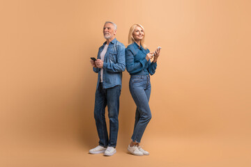 Fototapeta premium Senior couple use modern smartphones, reading text messages