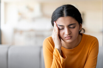 Stressed Young Indian Woman Suffering From Headache At Home