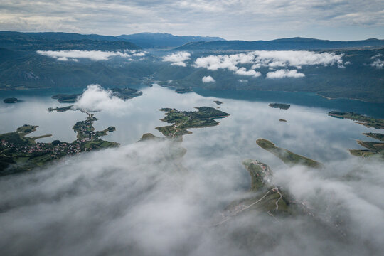 Aerial view of foggy Ramsko Jezero (Rama lake) in Prozor-Rama, Bosnia and Herzegovina.