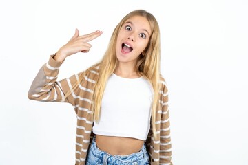 Beautiful caucasian teen girl foolishness around shoots in temple with fingers makes suicide gesture. Funny model makes finger gun pistol