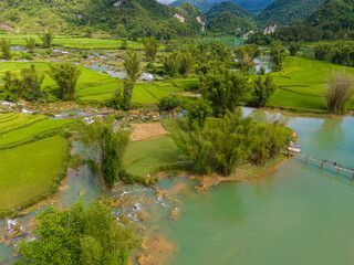 Aerial landscape in Quay Son river, Trung Khanh, Cao Bang, Vietnam with nature, green rice fields and rustic indigenous houses