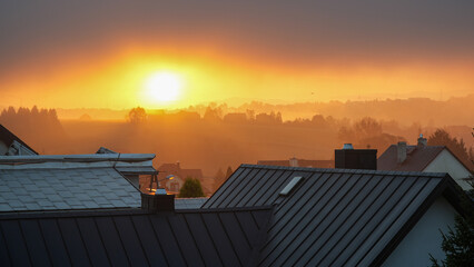 Sunrise over the roofs of the town - obrazy, fototapety, plakaty