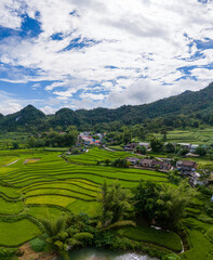 Aerial landscape in Quay Son river, Trung Khanh, Cao Bang, Vietnam with nature, green rice fields and rustic indigenous houses