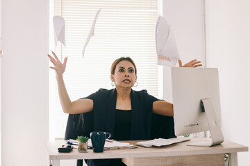 Upset mature Asian business woman throwing papers with angry expression  - Powered by Adobe