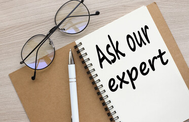 ASK OUR EXPERT open notebook with stickers and glasses .word on page