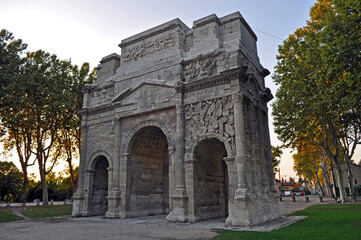 Fototapeta na wymiar Arc de Triomphe in Orange, France. Historical memorial building in the evening at sunset.