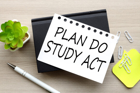 PDSA - Plan Do Study Act ,on a white page on a black notepad