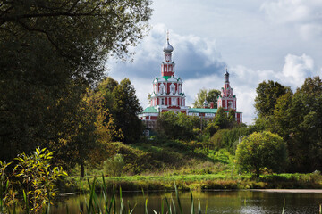 Red orthodox church near lake in Sofrino village, Russia