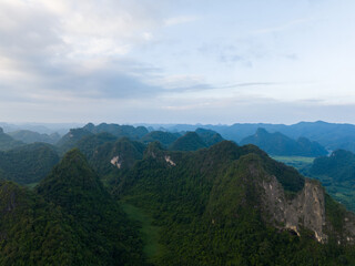 Fototapeta premium Aerial view of Thung mountain in Tra Linh, Cao Bang province, Vietnam with lake, cloudy, nature.