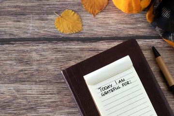 Today I am thankful for, handwritten text in small notebook, holy bible, pumpkin, and autumn leaves...