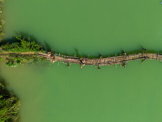 Aerial landscape in Phong Nam valley, farmers carry rice home at Cao Bang province, Vietnam with river, nature, green rice fields