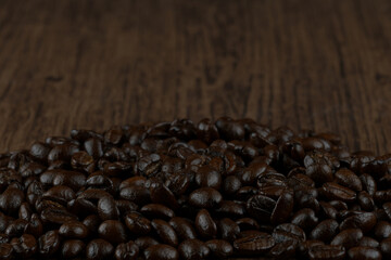 Roasted coffee bean on wooden table.