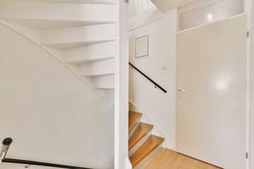 an empty staircase in a house with wood floors and white walls, as seen from the top down to the bottom