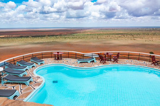 View of a swimming pool at Voi Safari Lodge at a scenic view point against valley at a lodge in Tsavo East National Park, Kenya
