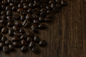 Roasted coffee bean on wooden table.