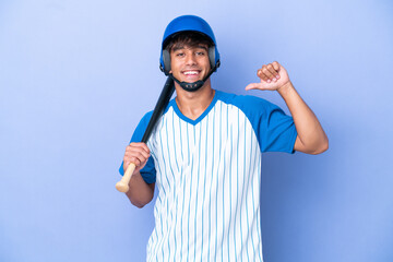 Baseball caucasian man player with helmet and bat isolated on blue background proud and self-satisfied