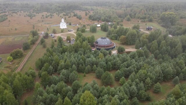 Fly above sphere houses in the middle of forest