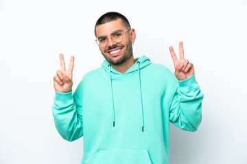 Fototapeta premium Young caucasian man isolated on white background showing victory sign with both hands