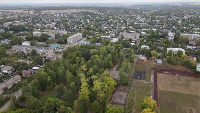 Cityscape of a small city with big stadium in summer