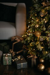 christmas tree with gifts at a cozy salon with low light