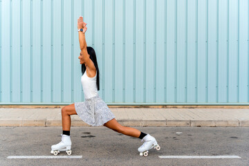 Middle aged skater woman with roller skates, doing yoga poses. © Alfonso Soler